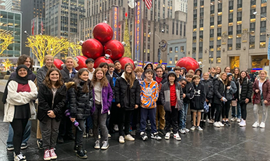  students pose at Radio City Music Hall